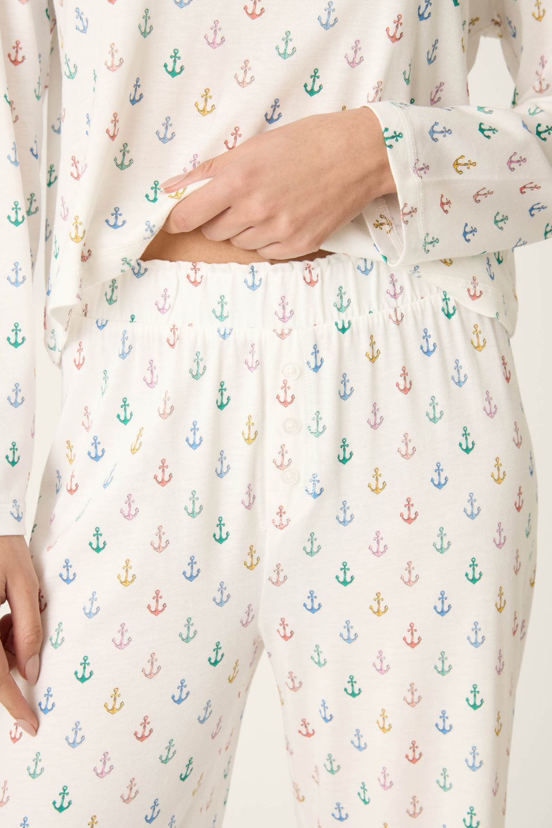 White fabric with a colorful rainbow anchor print.
