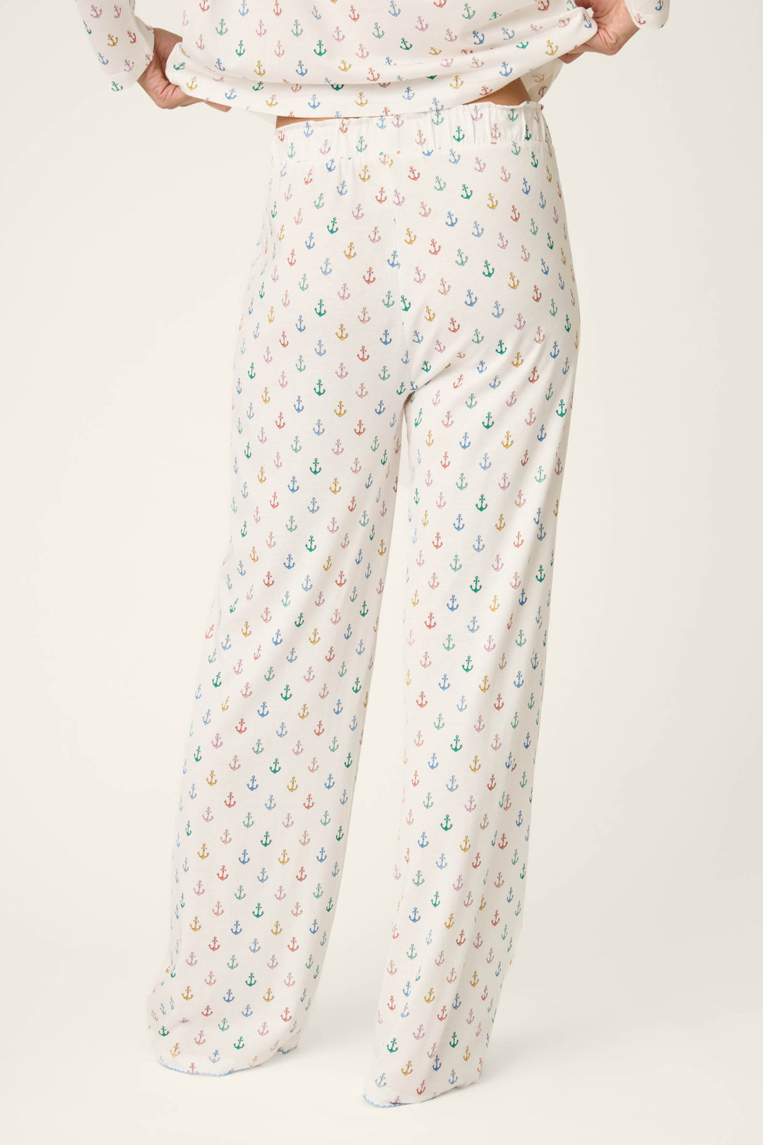 Fabric features a vibrant, multicolored anchor print on a soft, loose-textured material against a plain background.