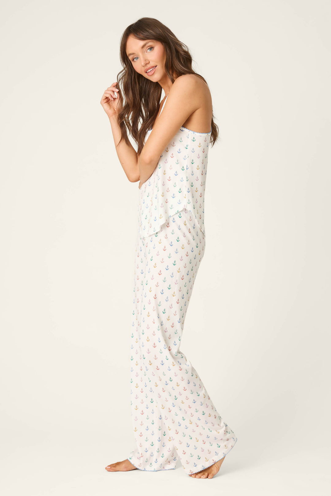 White fabric with a multicolored anchor print, featuring a smooth texture and playful rainbow motifs on a plain light background.