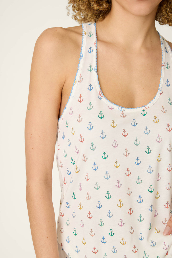 White fabric with a colorful anchor pattern and smooth texture.