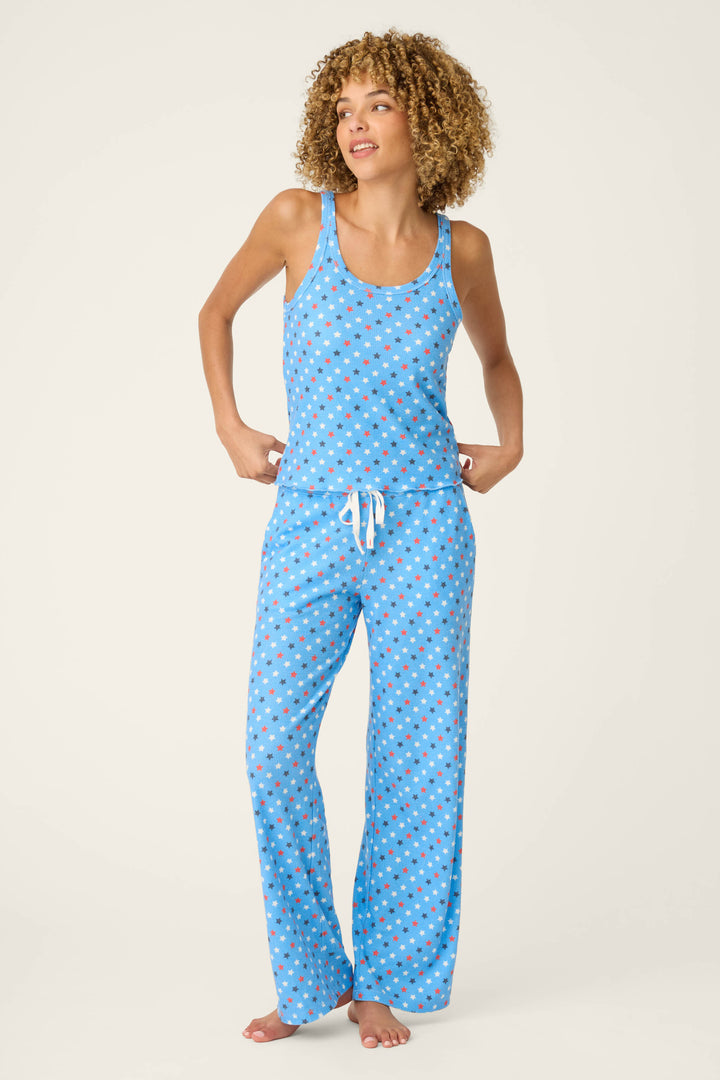 Fabric features a vibrant star pattern in various colors on a soft blue background, with a smooth and lightweight texture.