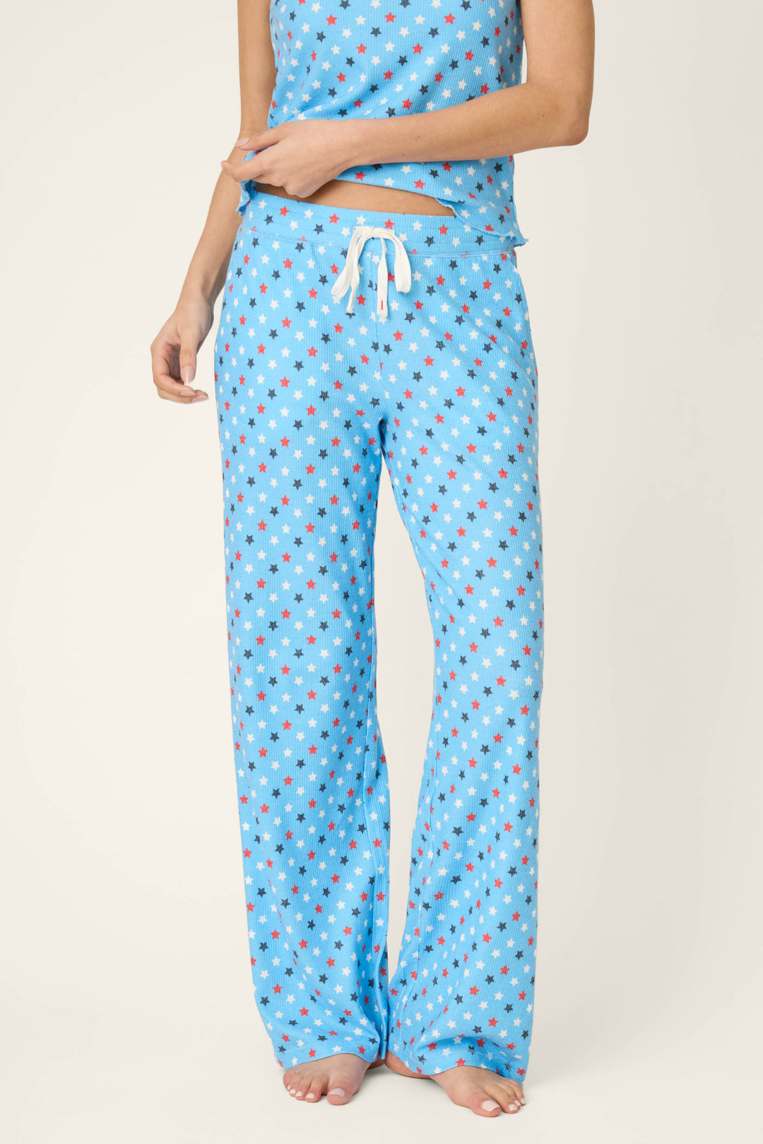 Bay blue fabric with a scattered white star print pattern and white drawstring, soft texture. Matching fabric partially visible.
