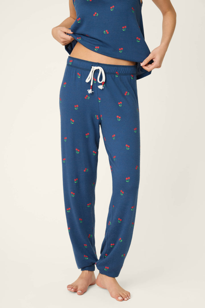 Fabric featuring a true navy background with a star-spangled pattern and cherry print, accented by a white drawstring detail.
