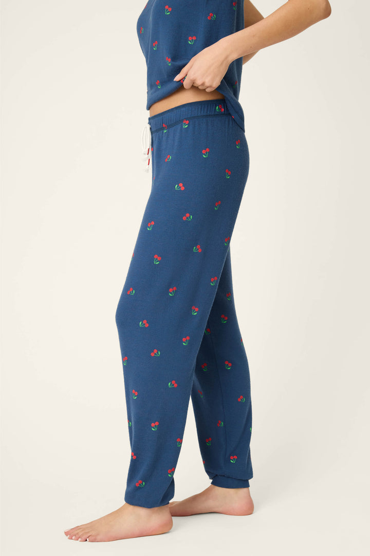True navy fabric with a star-spangled pattern and cherry print, featuring a banded, textured waistband.