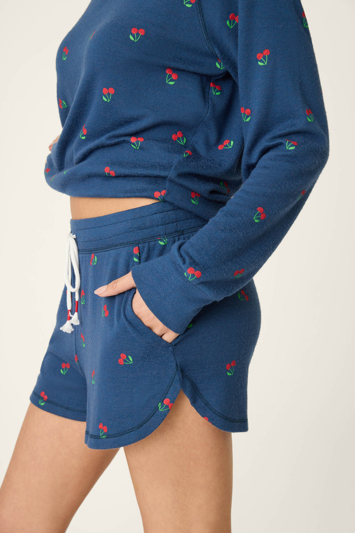 True navy fabric featuring a star-spangled cherry print pattern, smooth texture, displayed against a plain background.