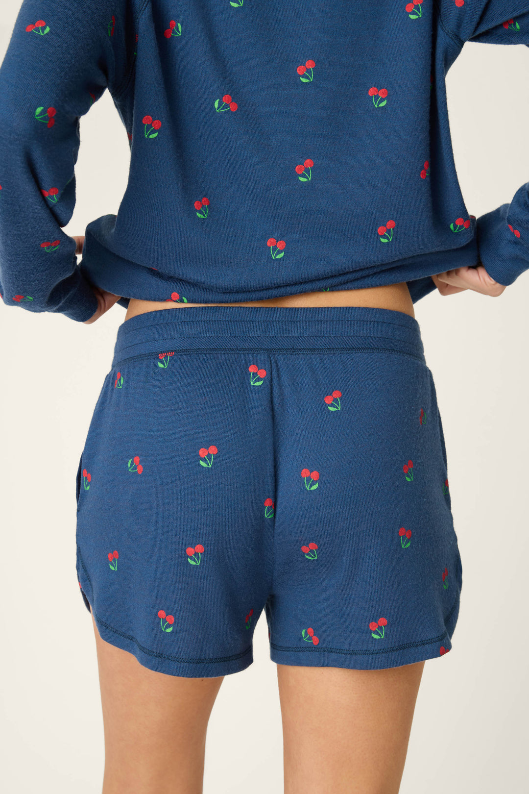 True navy fabric featuring a star-spangled pattern and cherry print design.