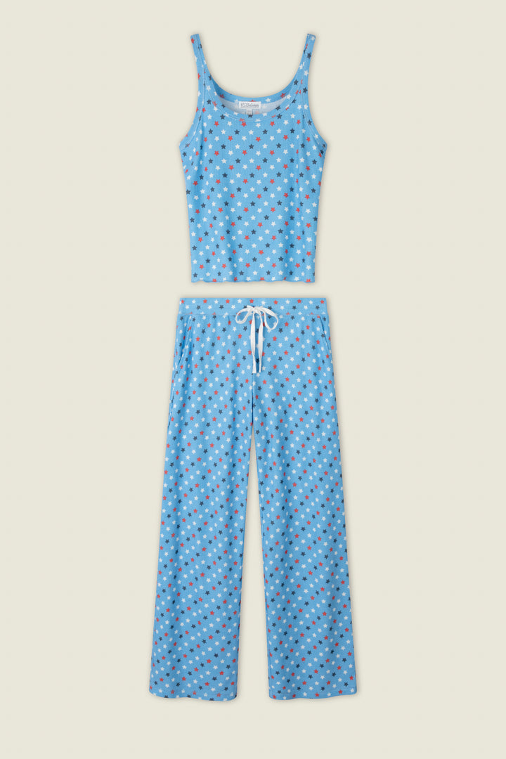 Blue fabric with small red, white, and blue star prints; includes a touch of white detail against the starry pattern.