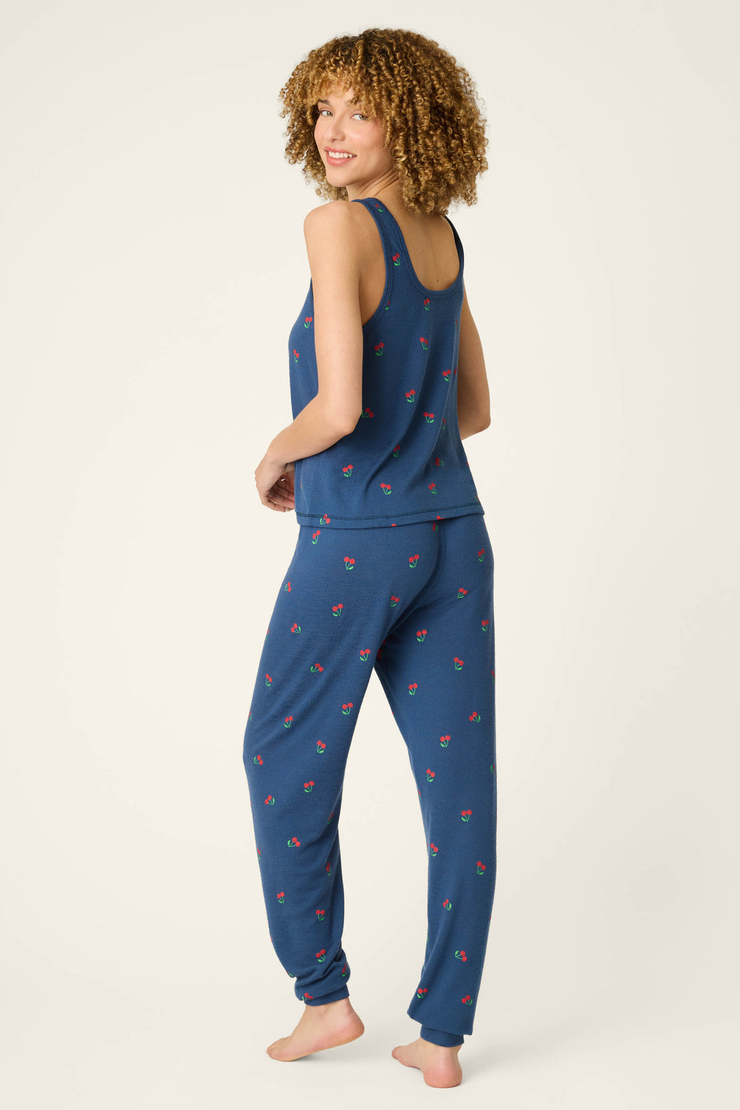 True navy fabric with a cherry print and subtle star-spangled summer pattern, smooth texture shown against a plain light background.