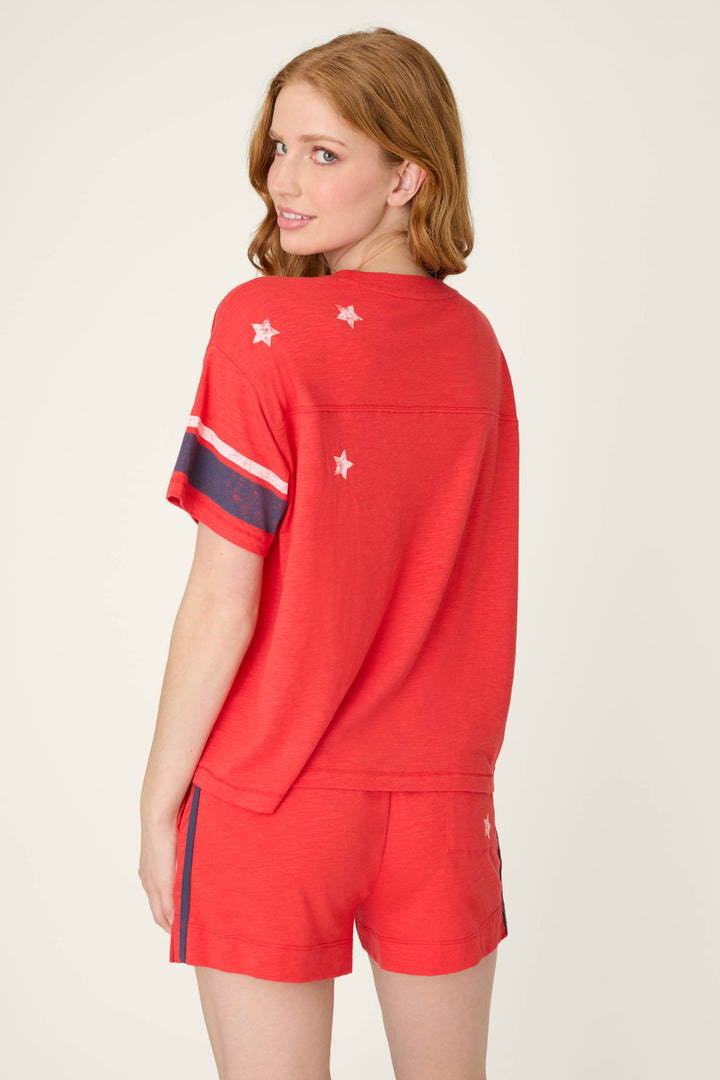 A vibrant true scarlet fabric featuring a star-spangled summer pattern in soft, lightweight material.