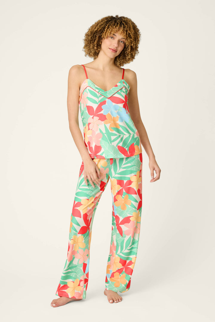 Tropical print fabric with red accents, featuring a vibrant and playful pattern in sunset-inspired hues.