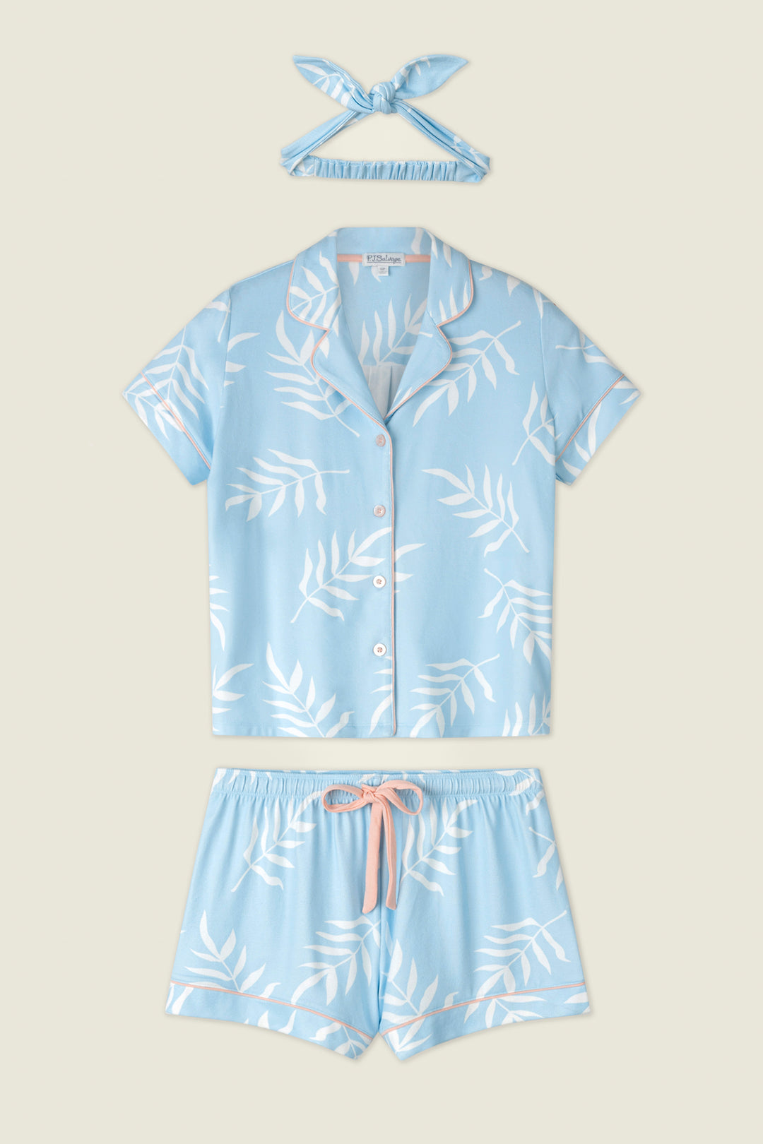 Light blue fabric with white leaf prints and pink drawstring ties, displayed on a neutral background.