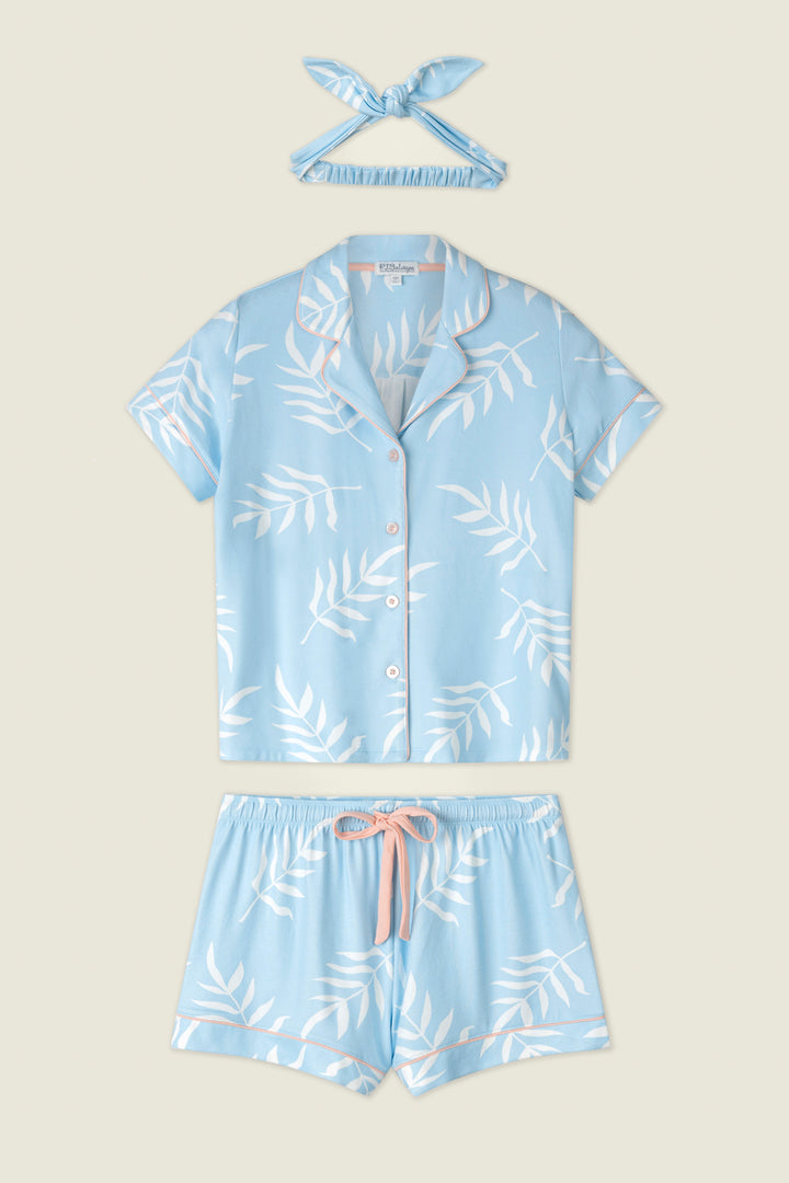 Light blue fabric with white leaf prints and pink drawstring ties, displayed on a neutral background.