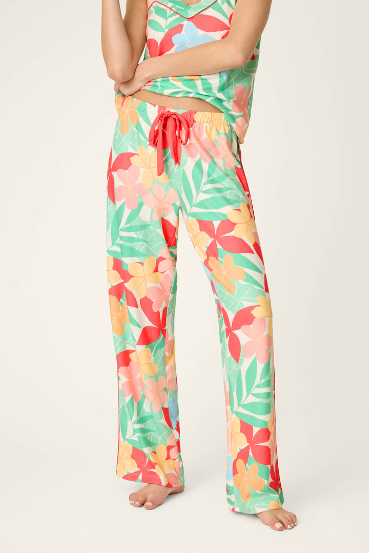 Vibrant tropical floral print in bold colors with a red drawstring accent; soft, smooth texture and loose, comfortable drape.