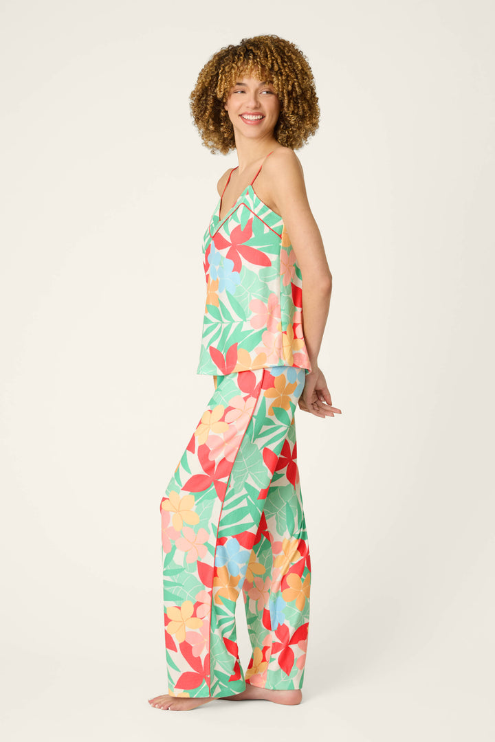 Vibrant green, red, orange, and yellow fabric with a lively pattern, featuring smooth texture and bold colors.