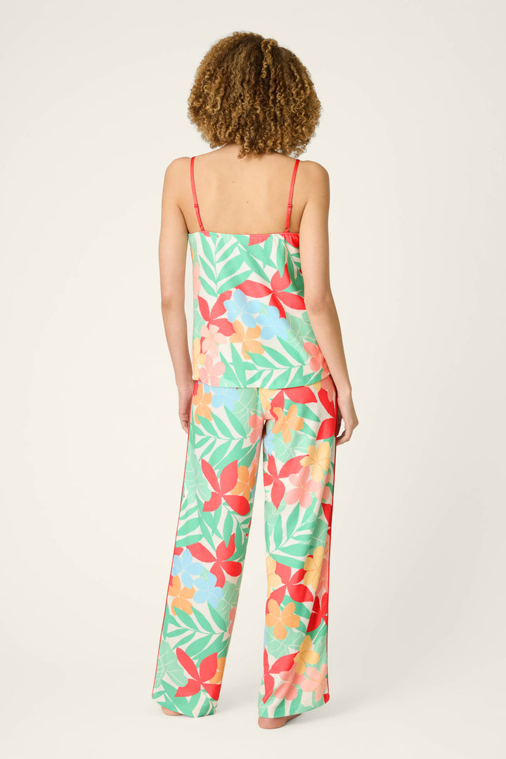 Colorful floral and leaf print with vibrant hues on a smooth, lightweight fabric; background is plain and light-colored.