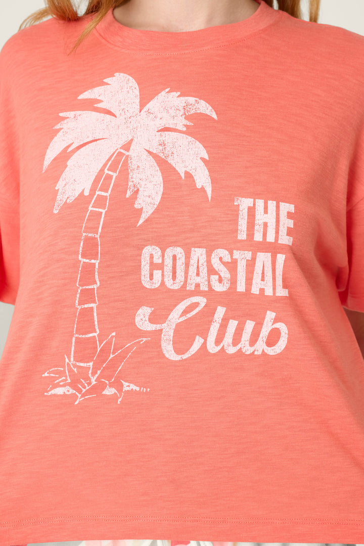 Coral fabric with a white palm tree graphic and "The Coastal Club" printed on the front.