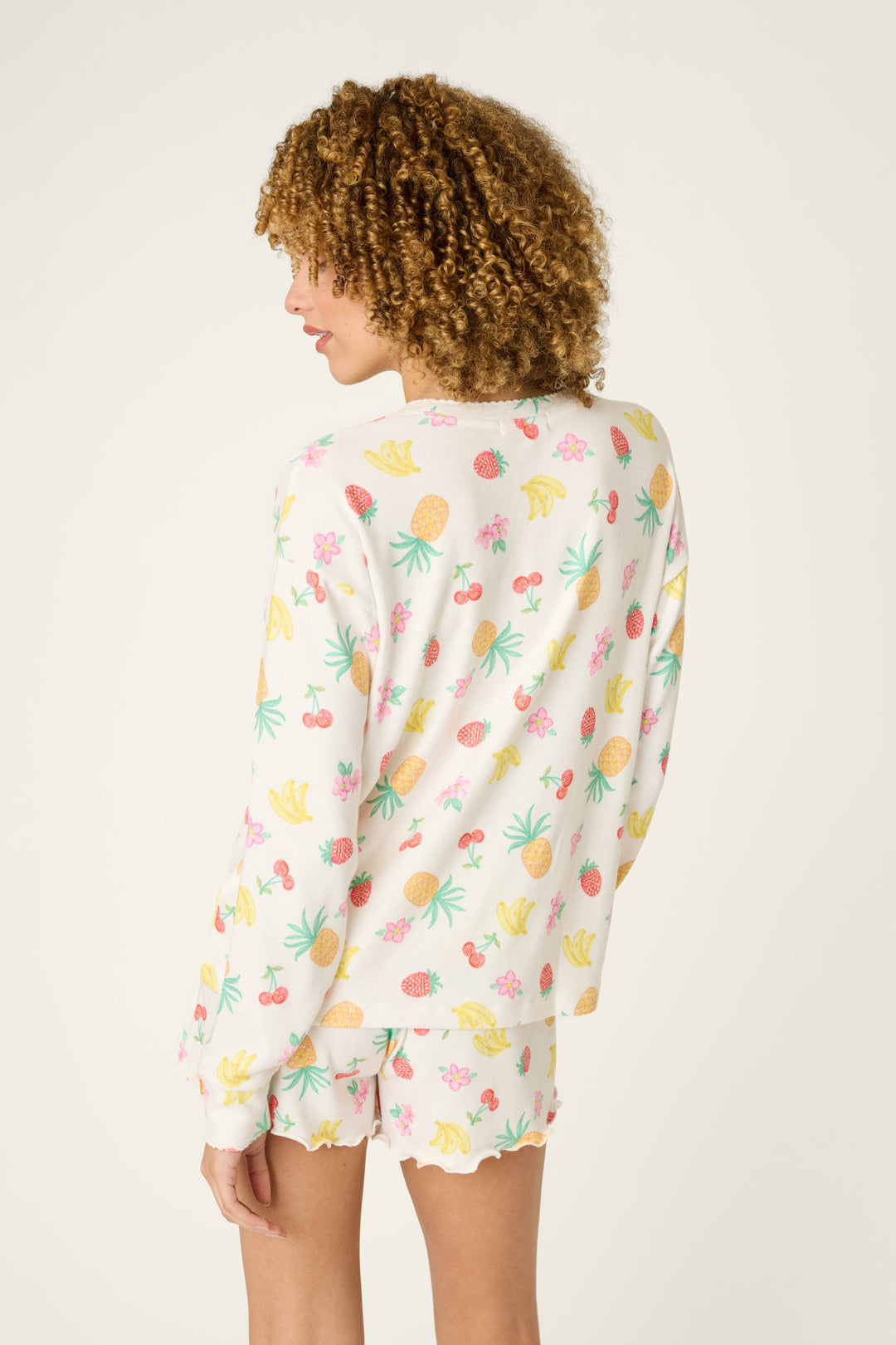 Colorful fruit pattern fabric with vibrant prints creating an energetic, festive look.