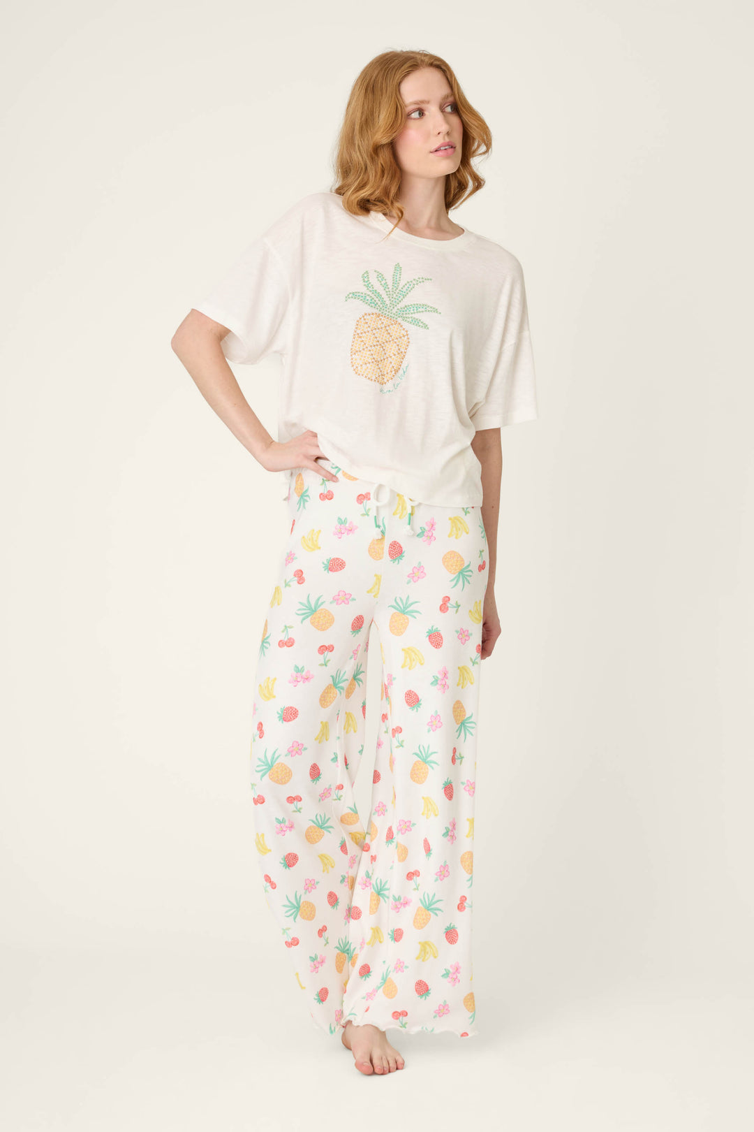Colorful fruit prints on fabric paired with a white textile featuring a pineapple graphic.