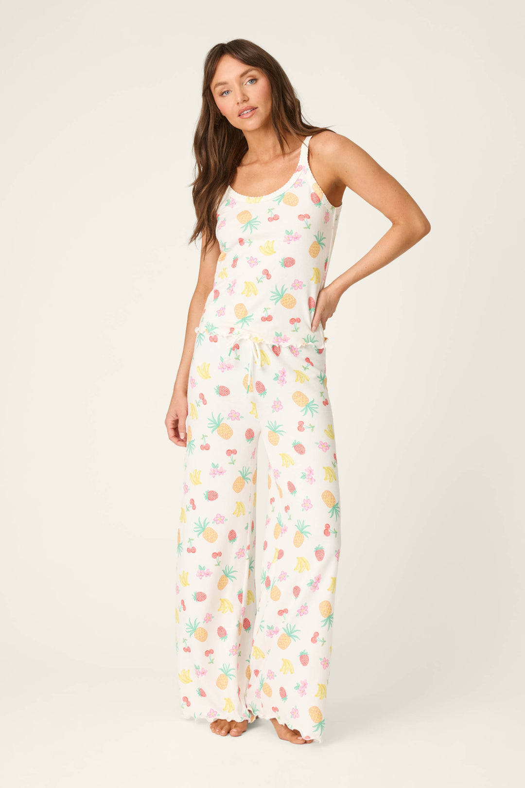 White fabric featuring a lively, colorful fruit and plant print with a smooth texture.