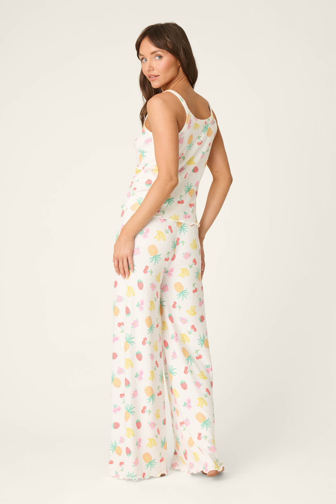 White fabric with colorful tropical fruit and leaf prints, smooth texture, shown on a plain white background.