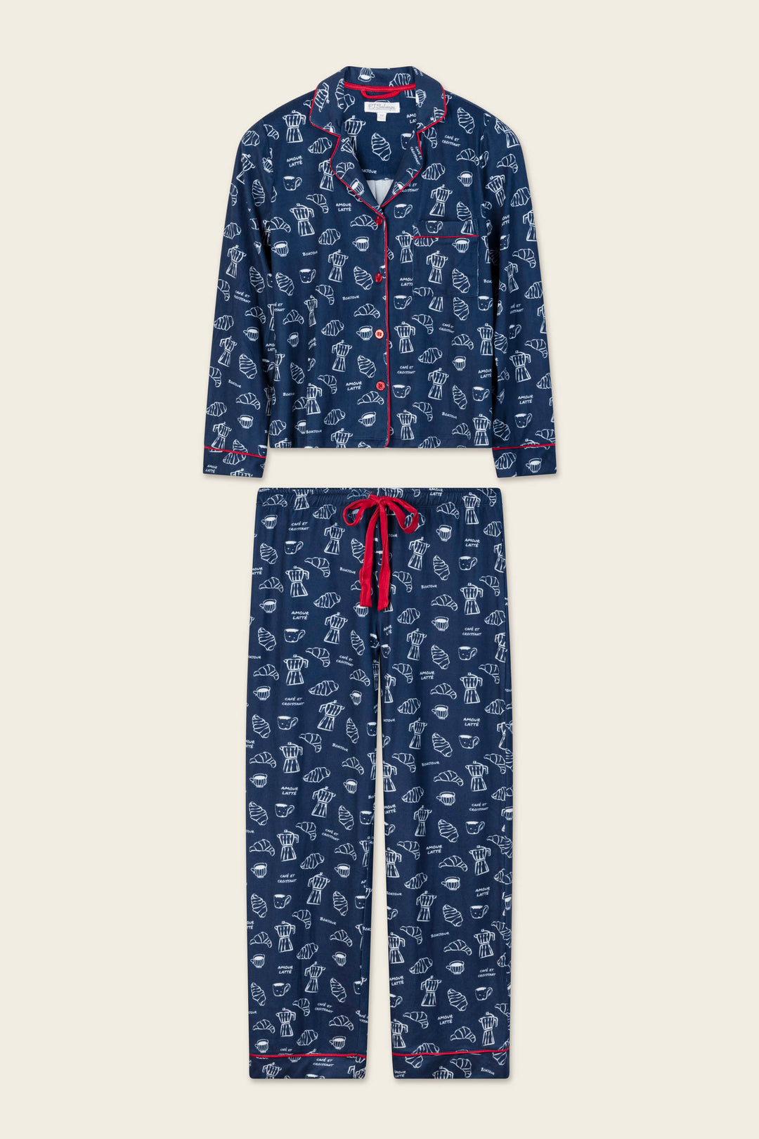 The Bonjour Babe French Breakfast Print Long Sleeve PJ Set by P.J. Salvage features a navy blue design with whimsical white line-drawn dog patterns, accented by red trim and a red drawstring. The set includes a long-sleeve buttoned top and matching pants.