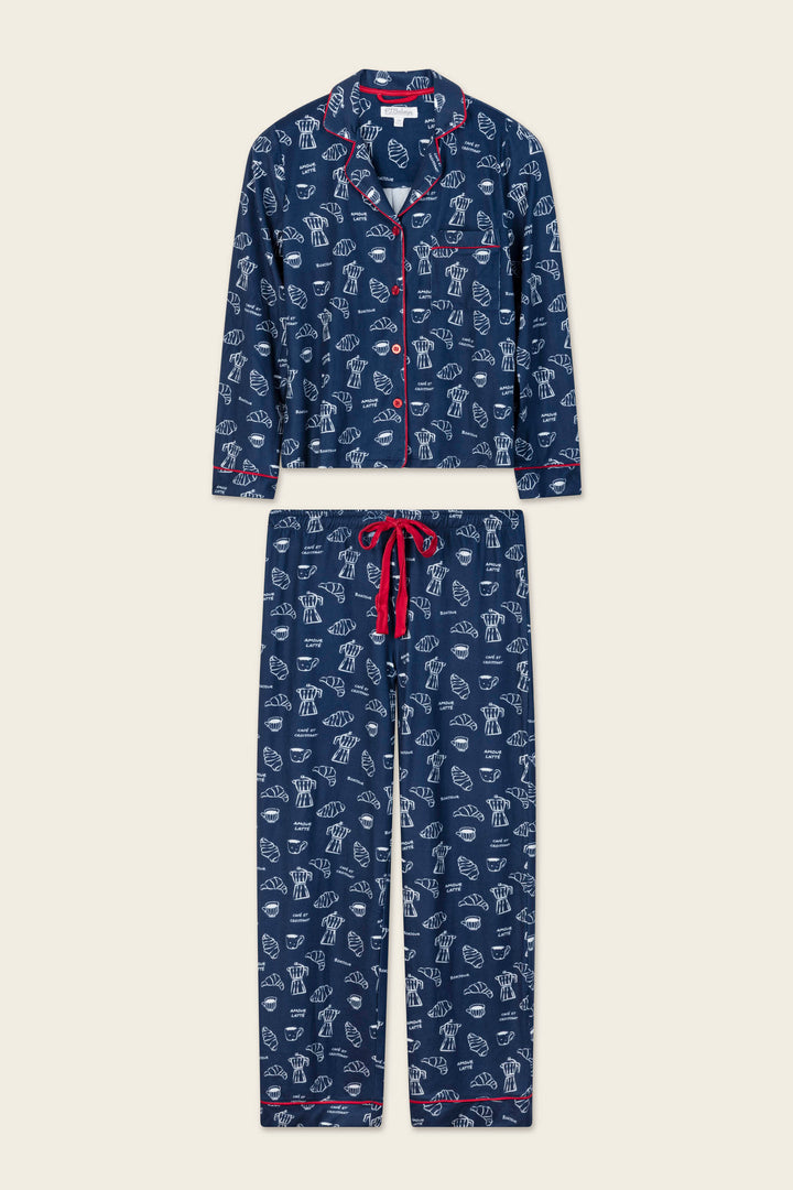 The Bonjour Babe French Breakfast Print Long Sleeve PJ Set by P.J. Salvage features a navy blue design with whimsical white line-drawn dog patterns, accented by red trim and a red drawstring. The set includes a long-sleeve buttoned top and matching pants.