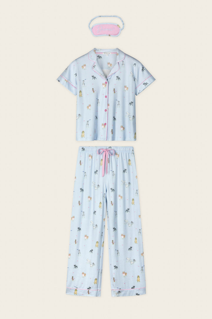 The Bark Park Fetch & Frolic 3-Piece PJ Set by P.J. Salvage features a light blue short-sleeve top, long pants, "Dream" sleep mask, cute animal prints, and pink accents—perfect women's sleepwear for dog lovers.