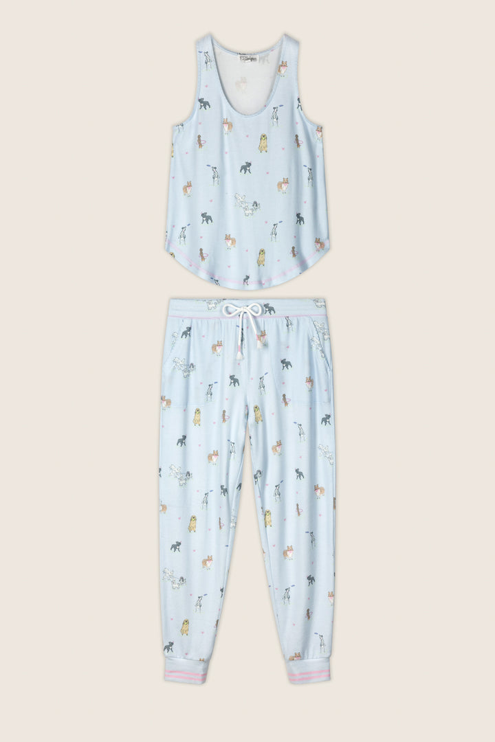 The Bark Park Fetch & Frolic Long PJ Set by P.J. Salvage features a light blue, peachy-soft sleeveless top and jogger pants with playful colorful dog print and cuffed ankles trimmed in white and pink for extra charm.