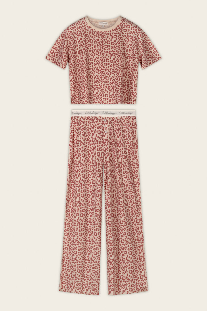 The P.J. Salvage Boyfriend Boxer Leopard Print Short Sleeve & Pants PJ Set features a bold red and white leopard print, with a short-sleeve cropped top and high-waisted, wide-leg pants finished with an elastic waistband.