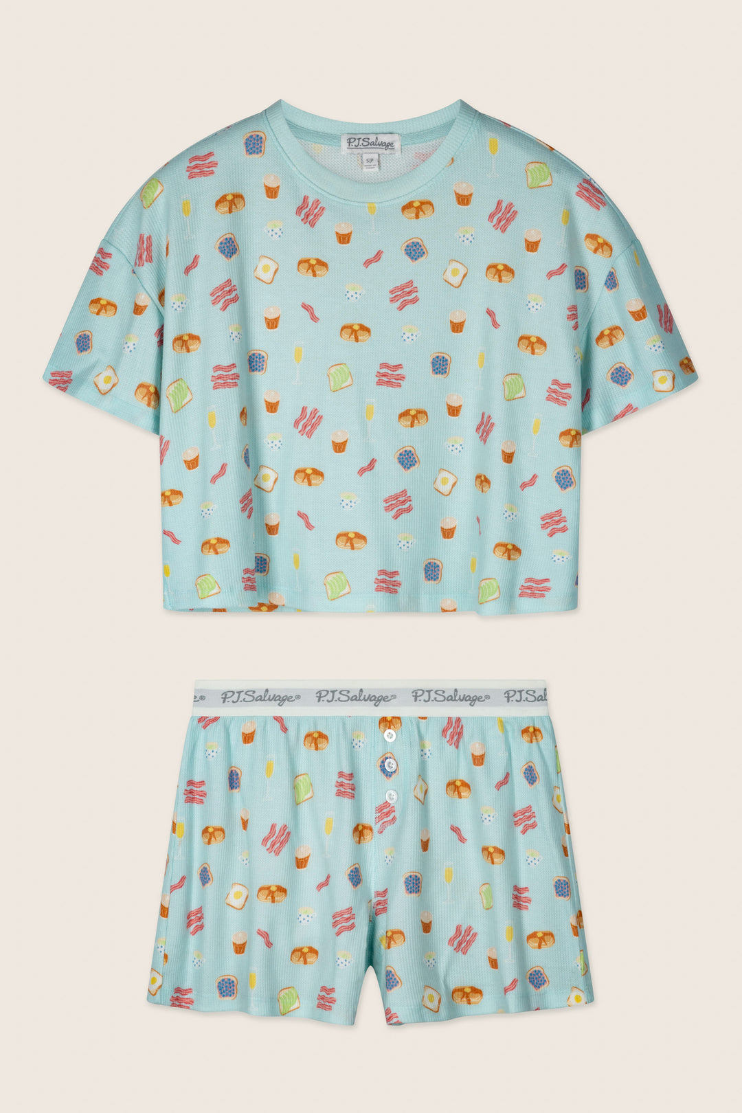 The Boyfriend Boxer Sunday Brunch Short PJ Set by P.J. Salvage features a light blue short-sleeve cropped top and matching shorts with a fun breakfast print of eggs, bacon, toast, and coffee, plus a branded waistband.