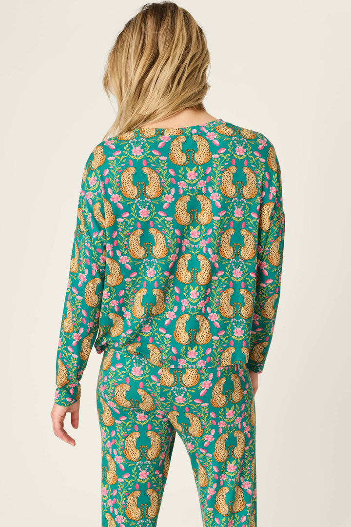 A person with long blonde hair wears the Cheetah Bonita Dreams Cheetah Print Long Sleeve Top by P.J. Salvage, shown from the back against a plain light background.