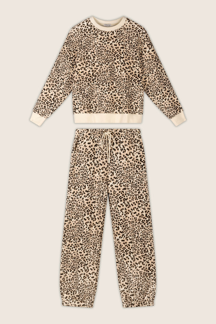 P.J. Salvage "C'est La Vie Leopard Print Frankie Sweater" two-piece lounge set, featuring a long-sleeve top and matching drawstring pants with a beige background and black leopard print, laid flat on a light surface.