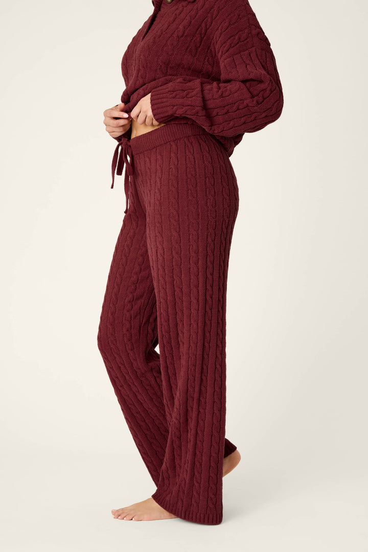 A person models the P.J. Salvage Cozy Chenille Cable Knit Dark Wine Lounge Pants, standing barefoot on a plain background, shown from shoulders to feet.