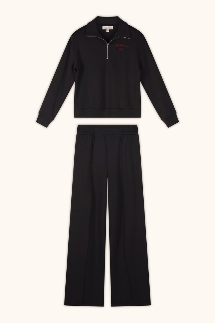 A pair of P.J. Salvage C'est La Vie Midnight Flights Runway Pants, styled with a zip-up long sleeve top, is laid flat on a light background.