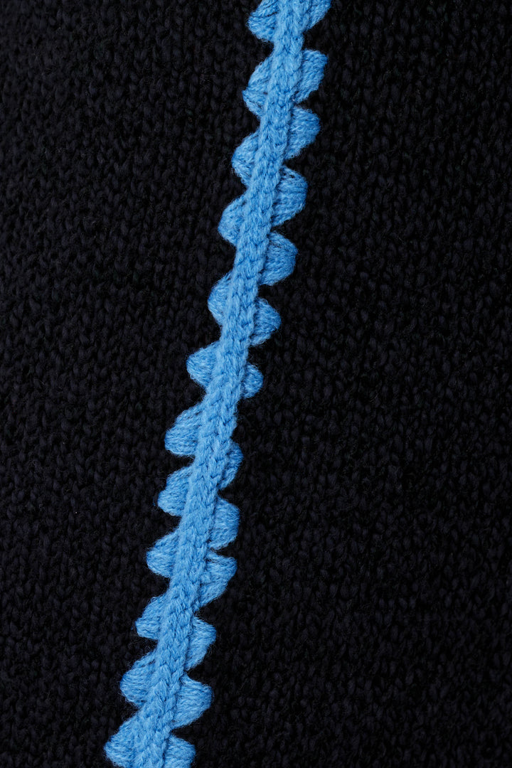 Close-up of the P.J. Salvage C'est La Vie Suki Jogger Pants, showcasing black knitted fabric with a vertical, textured blue zigzag stripe running down the center.