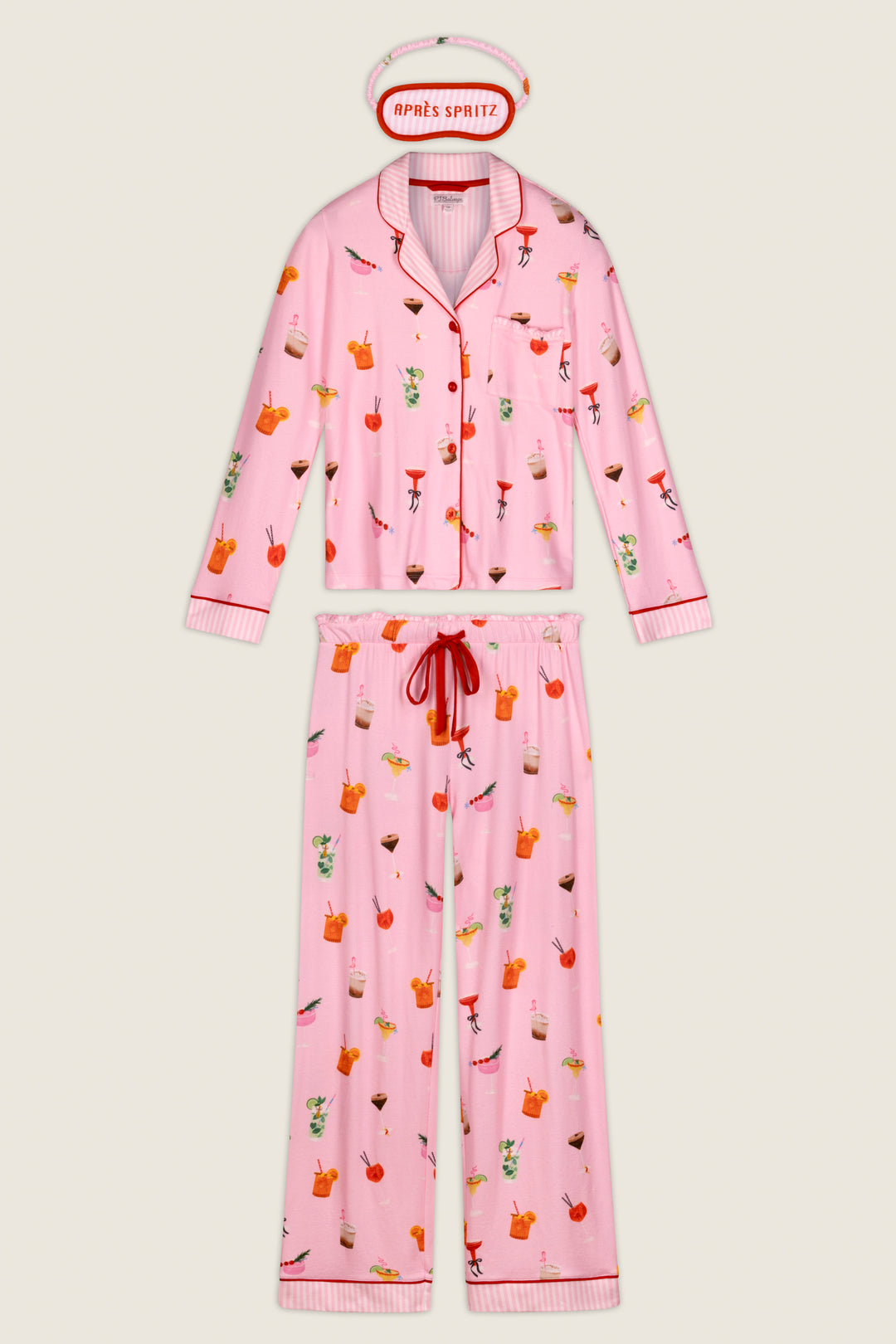 The First Chair, Last Call Cocktail Print 3-Piece PJ Set by P.J. Salvage features a pink pajama set with playful cocktail prints, red drawstring pants, red-and-white striped trim, and a coordinating pink sleep mask labeled APRÈS SPRITZ.