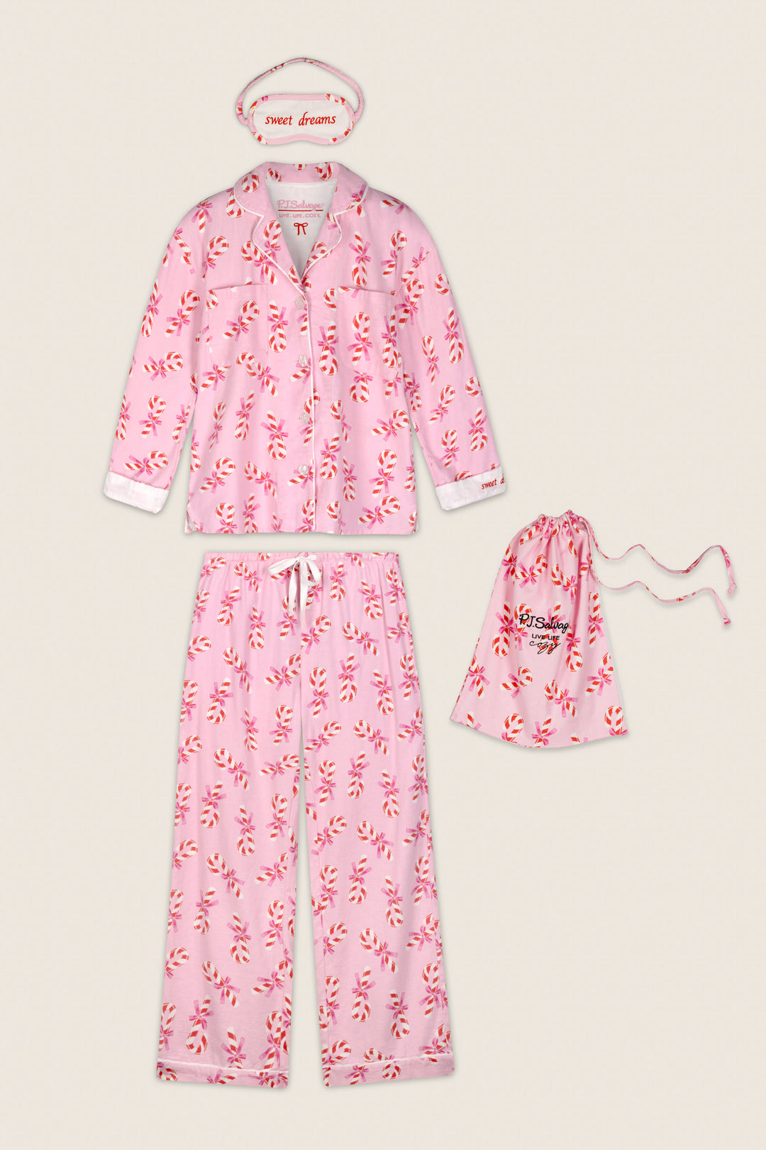 The Sweeter Than Sugar Candy Cane Print 4-Piece PJ Set by P.J. Salvage features a pink pajama set with a playful red and white candy cane print, including a long-sleeve top, pants, matching drawstring pouch, and a “sweet dreams” eye mask—all displayed on a beige background.