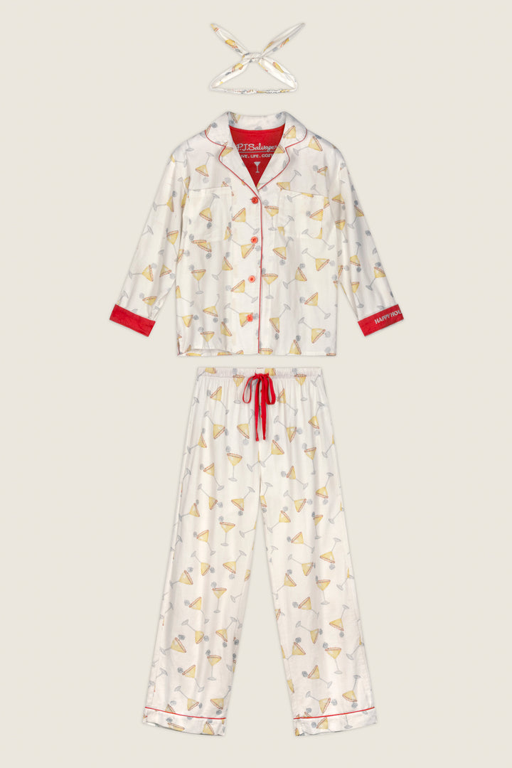 The P.J. Salvage Happy Hour Cocktail Print 3-Piece Flannel PJ Set features a white long-sleeve top, pants, and matching headband, each adorned with a playful martini glass print, red piping accents, and a coordinating red drawstring. The entire set is displayed flat against a light background.