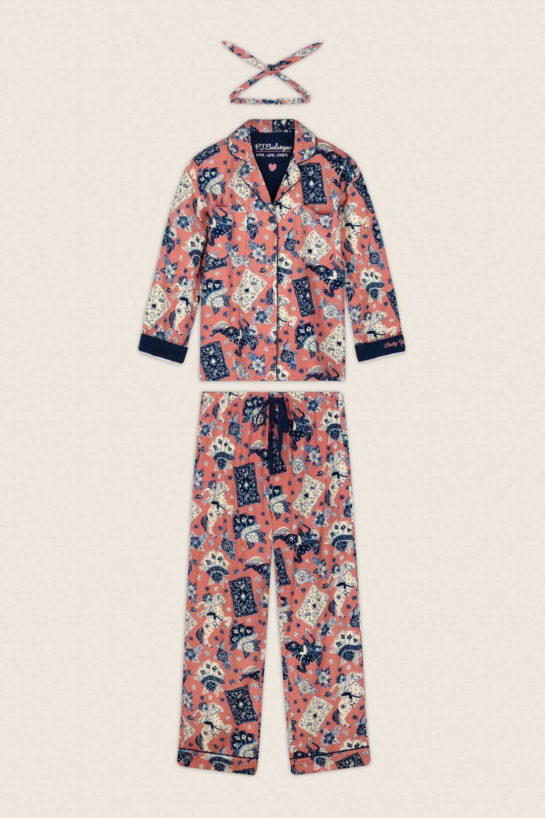 The P.J. Salvage Lucky in Love Western Print 3-Piece Long Sleeve Flannel PJ Set, featuring a colorful cat and floral print on a pink background, is displayed flat against a neutral surface with its matching headband.