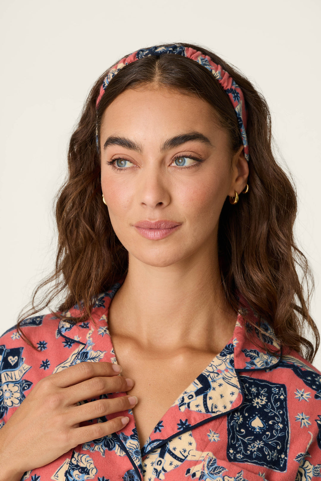A woman with long brown wavy hair wears the P.J. Salvage Lucky in Love Western Print 3-Piece Long Sleeve Flannel PJ Set, looking slightly to the side with a neutral expression against a plain background.