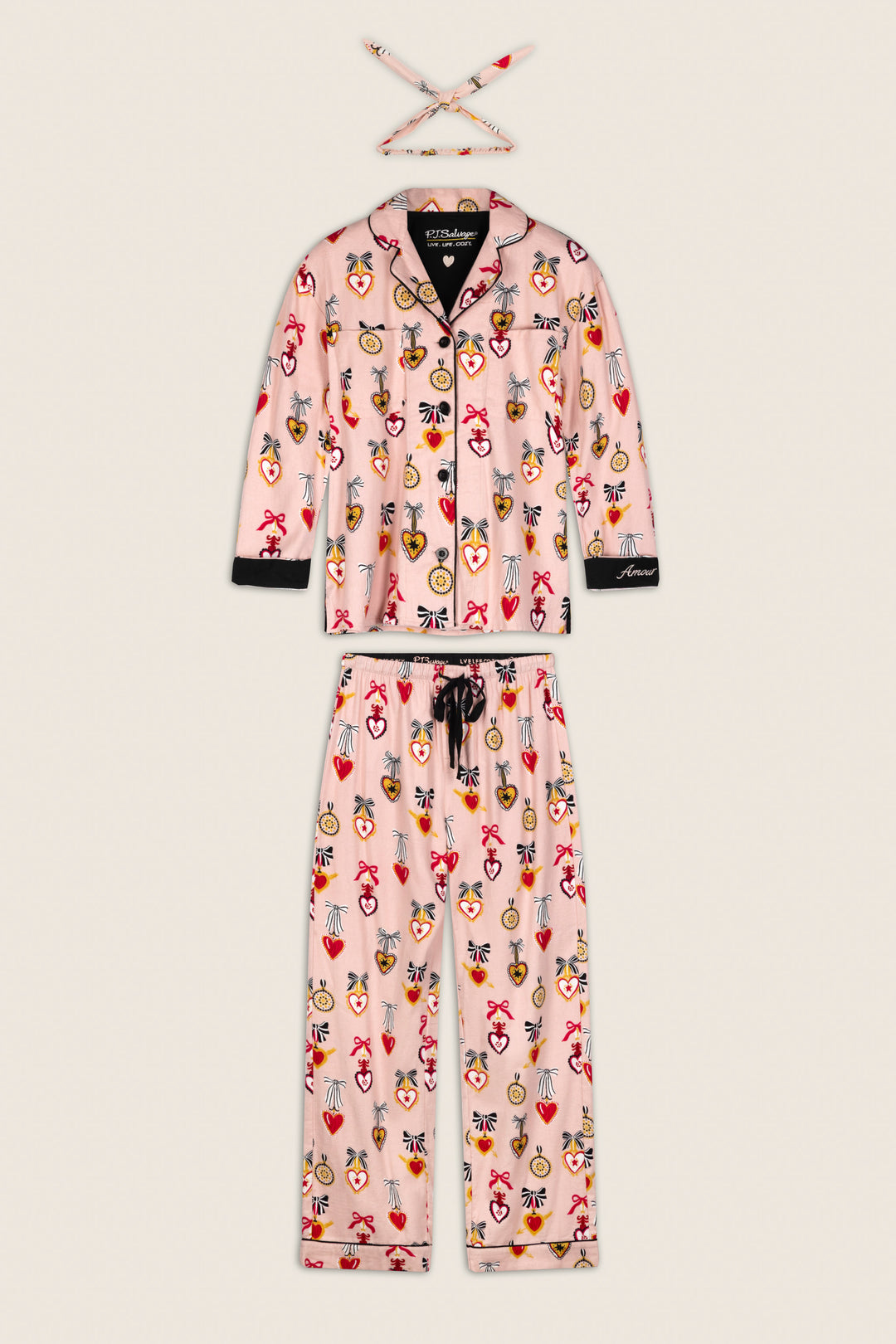 The Love Lockets Print 3-Piece Long Sleeve Flannel PJ Set by P.J. Salvage includes a pink jacket, pants, and a matching headband, all adorned with colorful heart, crown, and gemstone prints, and finished with black trim and buttons.