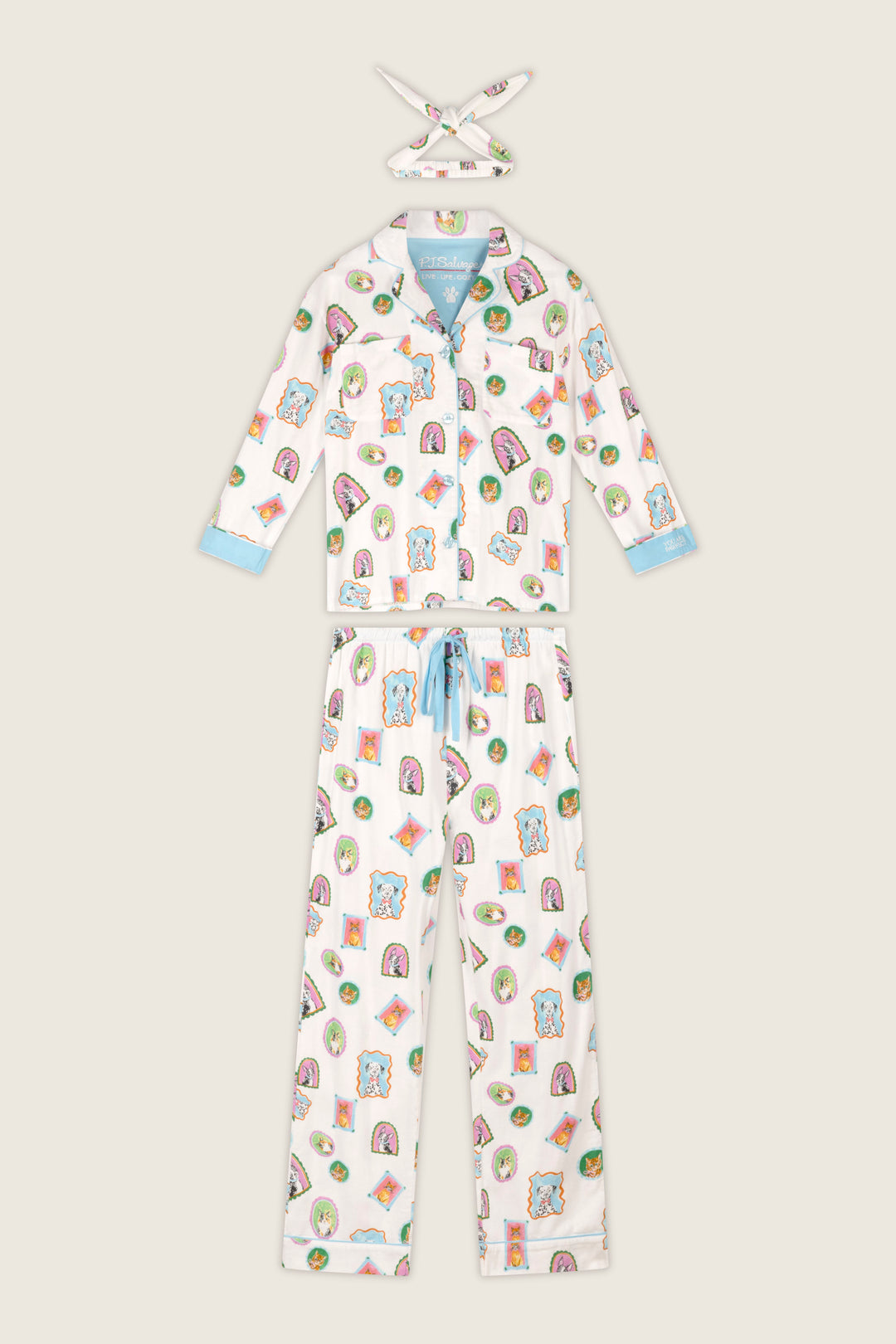 The Picture Purrfect Pet Portraits 3-Piece Flannel PJ Set by P.J. Salvage features a white pajama set adorned with colorful cartoon animal prints, blue trim on the sleeves and pant cuffs, a blue drawstring at the waist, and a matching fabric headband. The pajamas include long sleeves and full-length pants for cozy comfort.