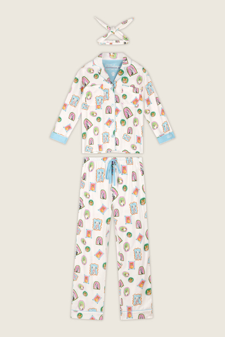 The Picture Purrfect Pet Portraits 3-Piece Flannel PJ Set by P.J. Salvage features a white pajama set adorned with colorful cartoon animal prints, blue trim on the sleeves and pant cuffs, a blue drawstring at the waist, and a matching fabric headband. The pajamas include long sleeves and full-length pants for cozy comfort.