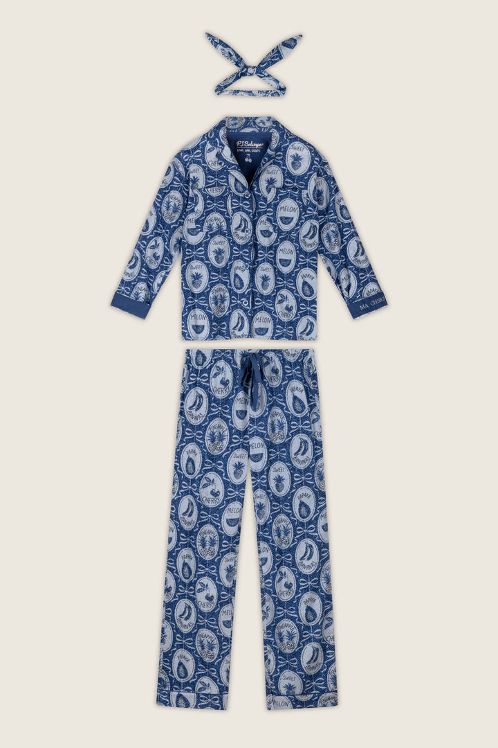 Fruit Medley Print 3-Piece Flannel PJ Set by P.J. Salvage, featuring a blue and white fruit medley pattern with a long-sleeve top, long pants, and a coordinating headband—all adorned with vintage-style illustrations.