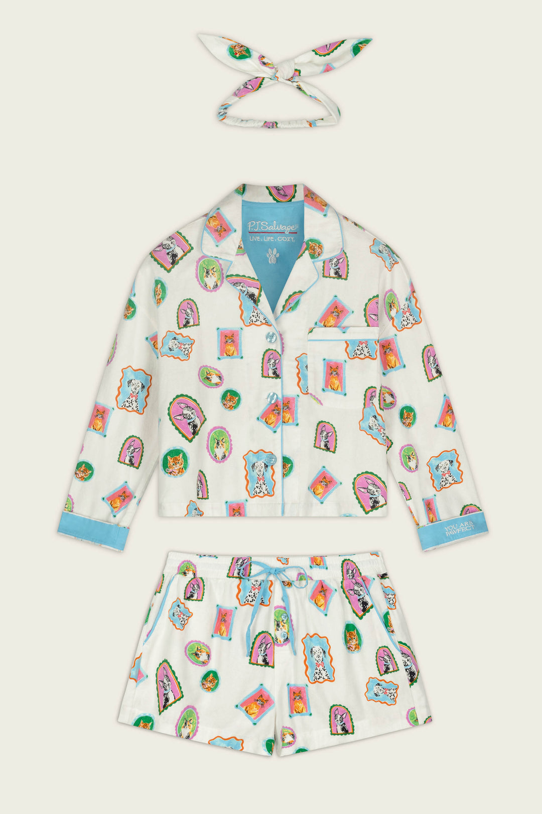 The Picture Purrfect Pet Portraits 3-Piece Short Flannel PJ Set by P.J. Salvage is a children’s pajama set with a matching headband, featuring colorful cartoon animal faces on a white background and blue accents on the cuffs, collar, and hems.