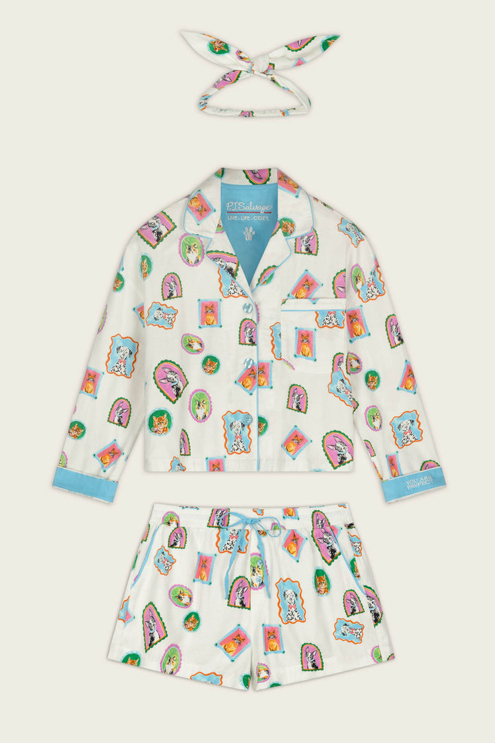The Picture Purrfect Pet Portraits 3-Piece Short Flannel PJ Set by P.J. Salvage is a children’s pajama set with a matching headband, featuring colorful cartoon animal faces on a white background and blue accents on the cuffs, collar, and hems.