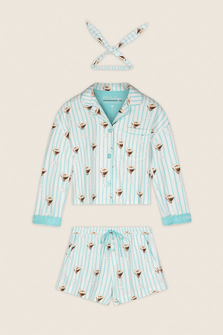 The Espresso Martini Print 3-Piece Flannel PJ Set by P.J. Salvage, featuring a long-sleeve shirt, drawstring shorts, and a matching headband with light blue and white stripes and coffee cup motifs, is laid flat on a cream background.