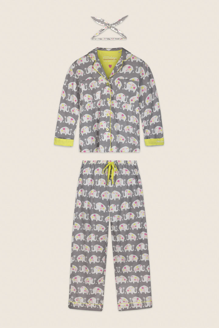 The Blooms on Parade Elephant Print 3-Piece Flannel PJ Set by P.J. Salvage features a children’s gray pajama set with a repeating white elephant print, lime green trim, and a yellow drawstring. The set includes a long-sleeve top, pants, and a matching headband laid above.