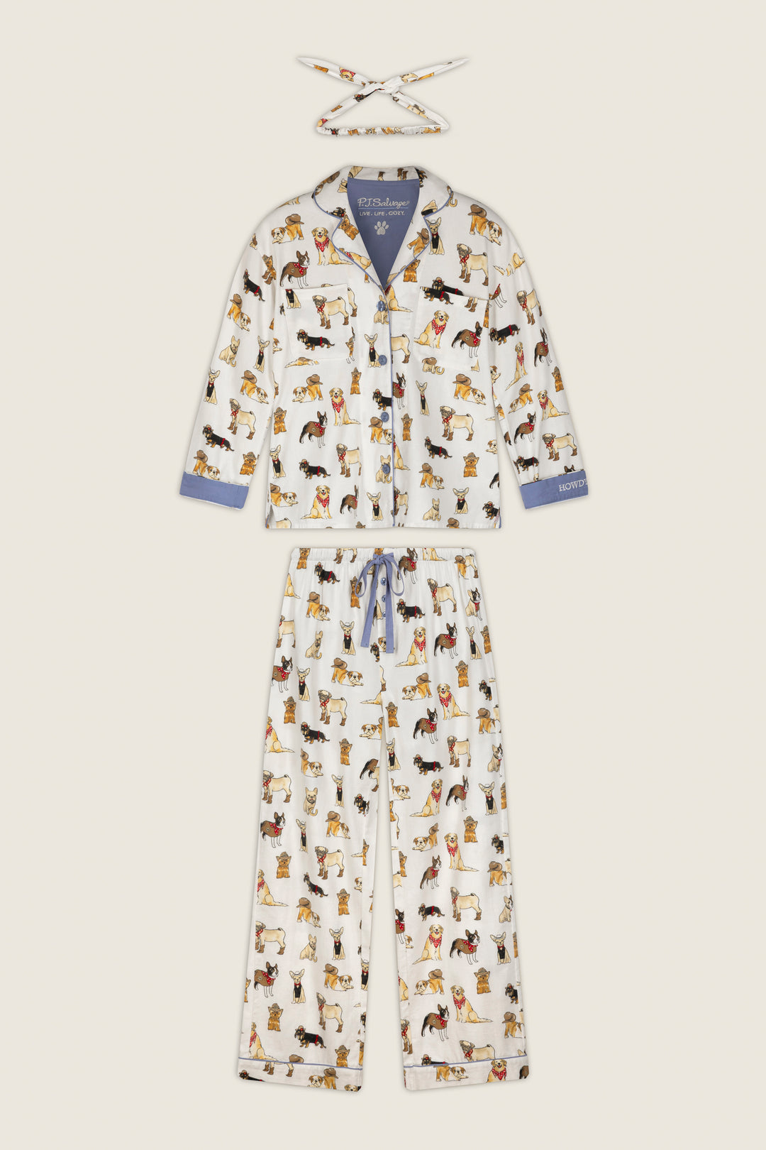 The Howdy Pup-ner Dog Print 3-Piece Flannel PJ Set by P.J. Salvage features a white pajama set with playful, colorful dog illustrations. This set includes a matching headband, a top with blue accents on the collar and cuffs, and full-length relaxed fit pants.