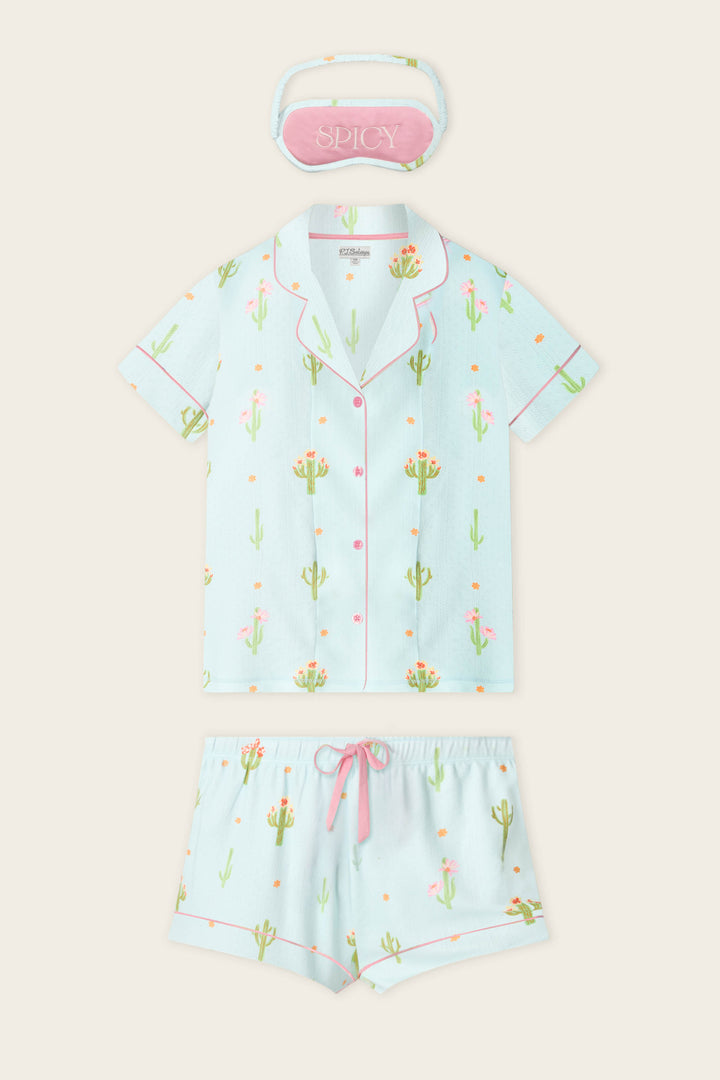 The Feelin' Prickly Cactus Blooms 3-Piece Short PJ Set by P.J. Salvage includes a light blue pointelle pajama set with cactus and llama print, pink trim, matching shorts with pink drawstring, and a pink "SPICY" sleep mask.